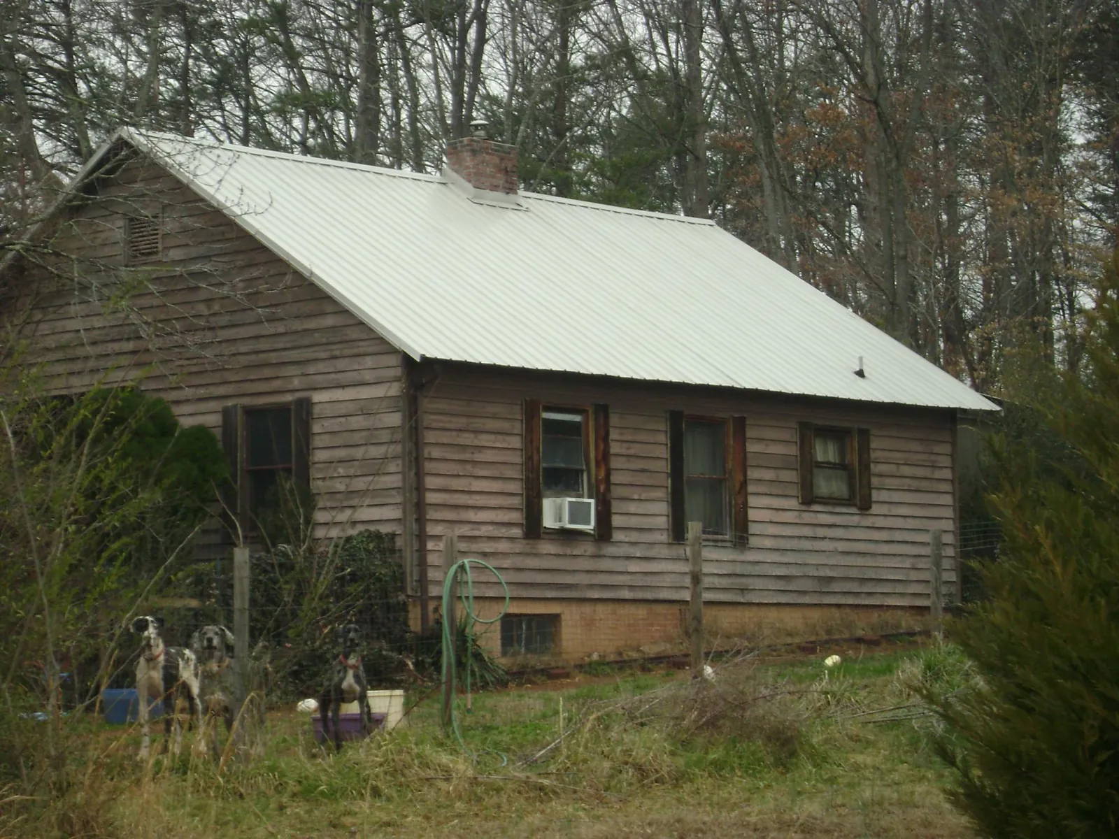 White metal roof on an old wood sided farmhouse, from a Metal Roof Installation job in Wetumpka